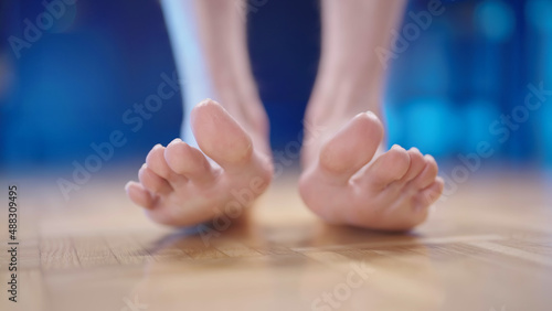 Person feet stand on heels with hallux valgus photo