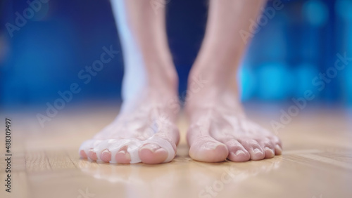 Person feet with silicone toe corrector spreader close-up low angle © Video_StockOrg