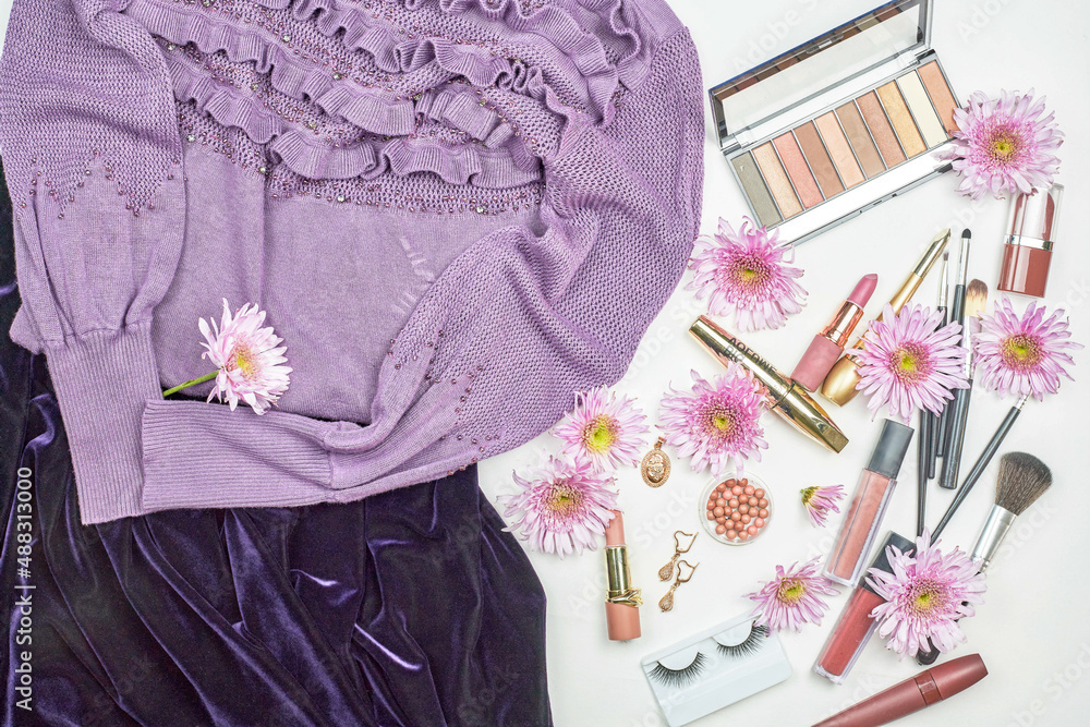 Women's makeup items with flowers and sweater Women's makeup items with flowers and sweater