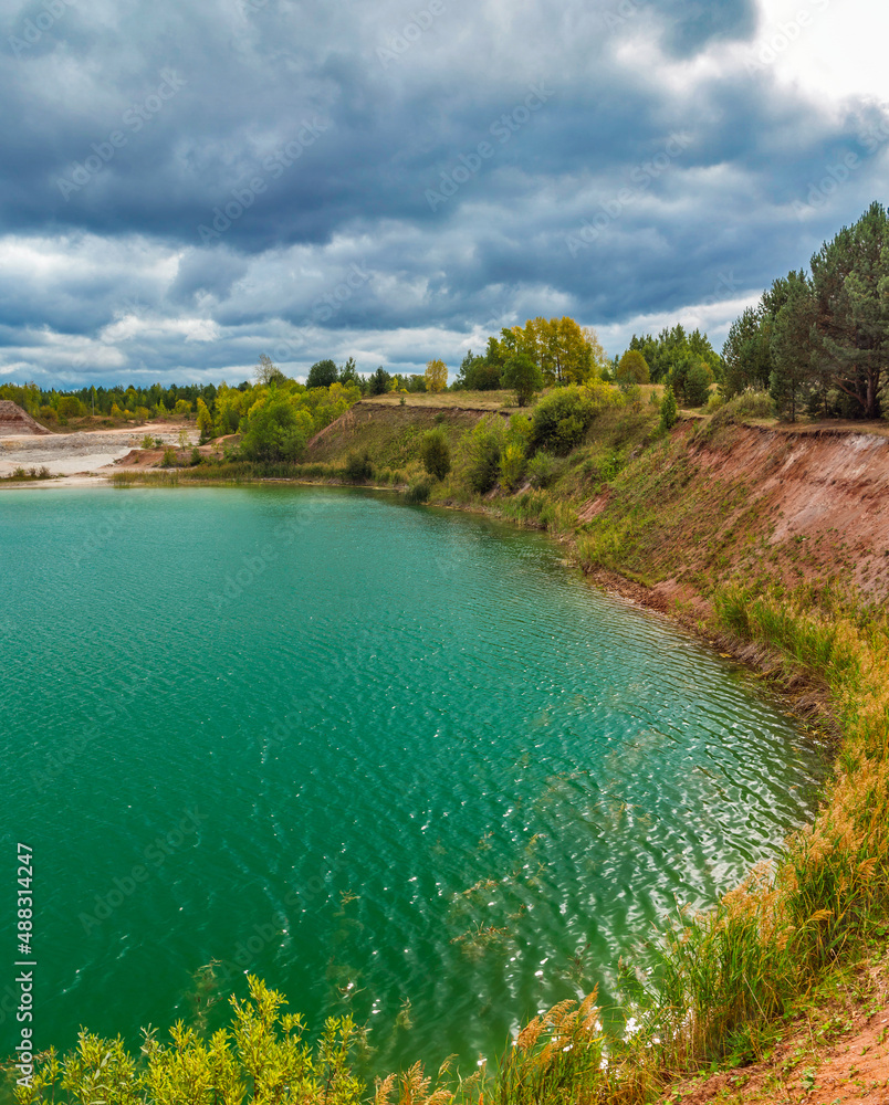lake in the limestone quarry on a cloudy gloomy summer day lake in the limestone quarry on a cloudy gloomy summer day
