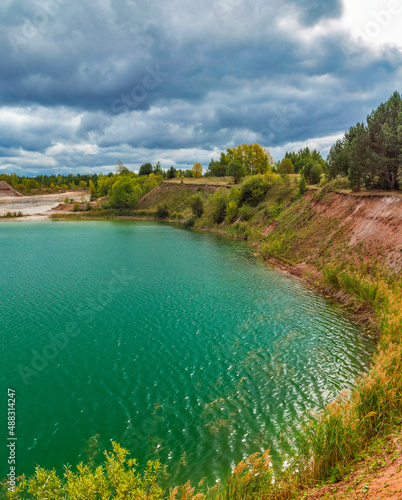 lake in the limestone quarry on a cloudy gloomy summer day