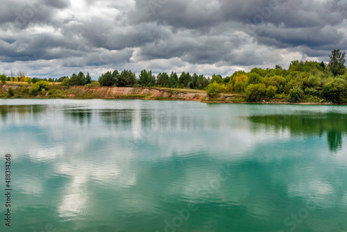 lake in the limestone quarry on a cloudy gloomy summer day