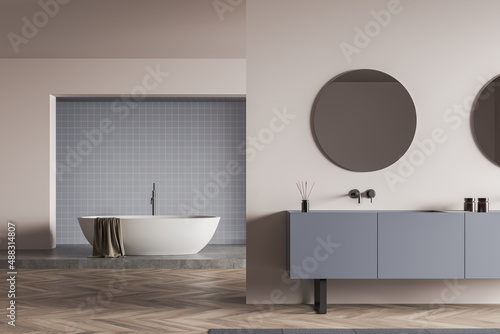 Light bathroom interior with bathtub and sink with mirror