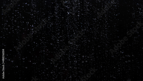 Water droplets on the black glass.