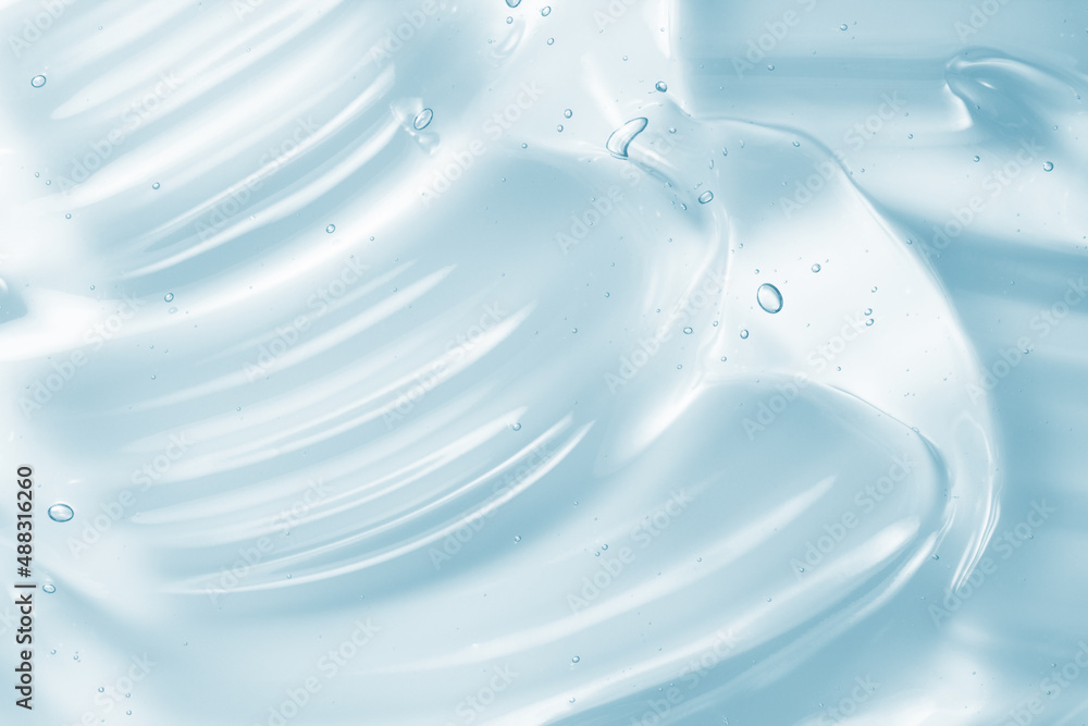 Clear gel serum texture. Blue liquid skincare cream background. Cosmetic gel product with