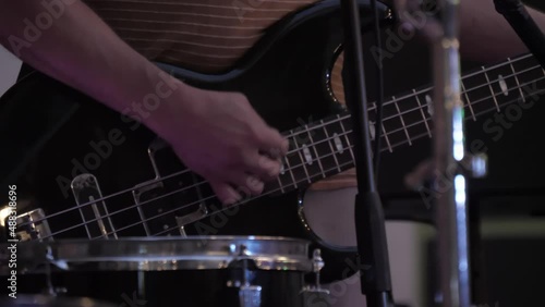 guitar player playing bass guitar in concert slow motion 4k