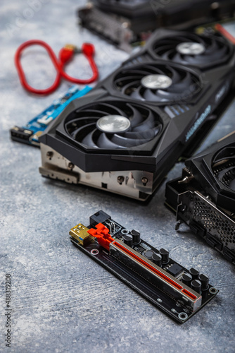 Gaming video card, video card adapter on a concrete background for video games and cryptocurrency mining. Computer parts. GPU card. 