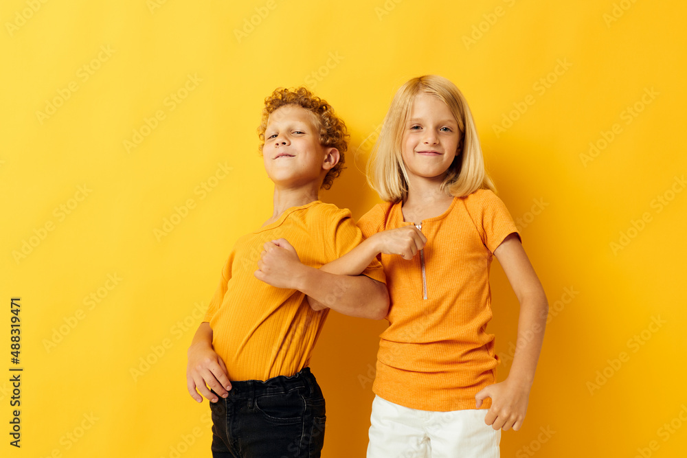 picture of positive boy and girl cuddling fashion childhood entertainment isolated background picture of positive boy and girl cuddling fashion childhood entertainment isolated background