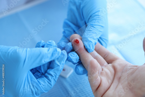 Photographie Doctor takes blood sample of patient serological test for PRP blood antibodies