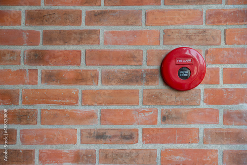Red Fire Alarm on brick wall