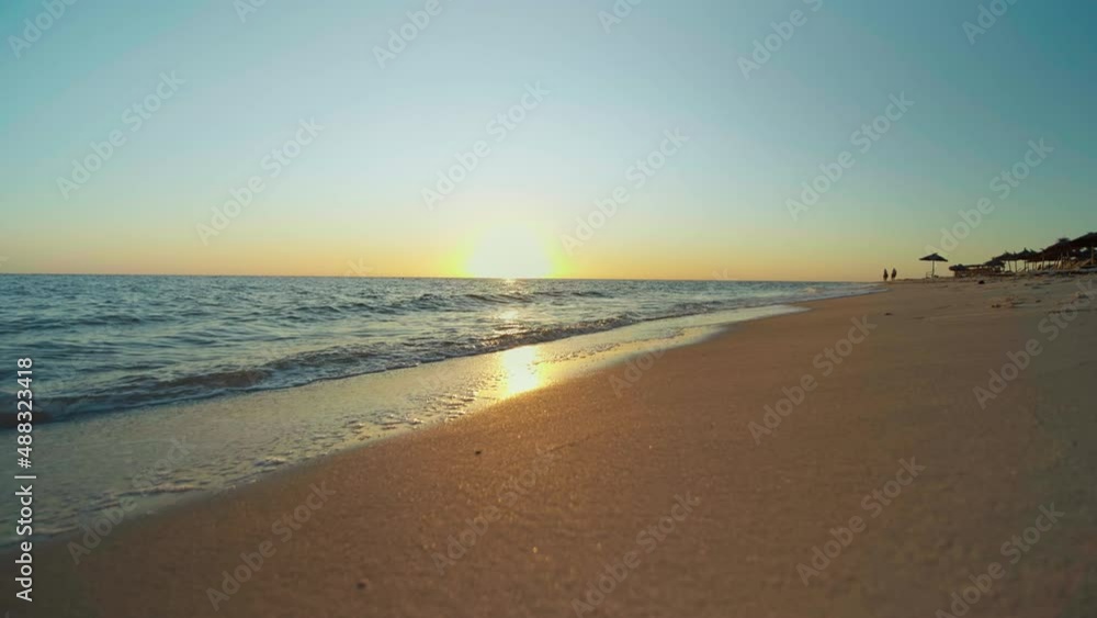 Sunset on the beach, shining golden waves in Tunisia, Africa. Beautiful landscape, travel destinations, enjoying holiday, Mediterranean Sea, vacantion seaside. Sunset on the beach, shining golden waves in Tunisia, Africa. Beautiful landscape, travel destinations, enjoying holiday, Mediterranean Sea, vacantion seaside.