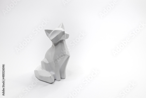 Cat figurine in origami style with a white background