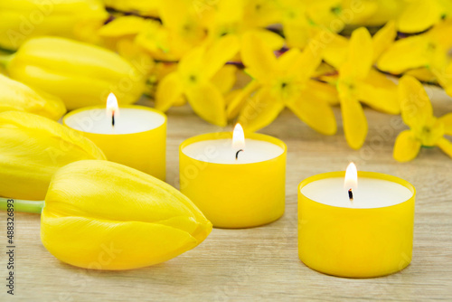 Yellow decorations with candles and tulips closeup