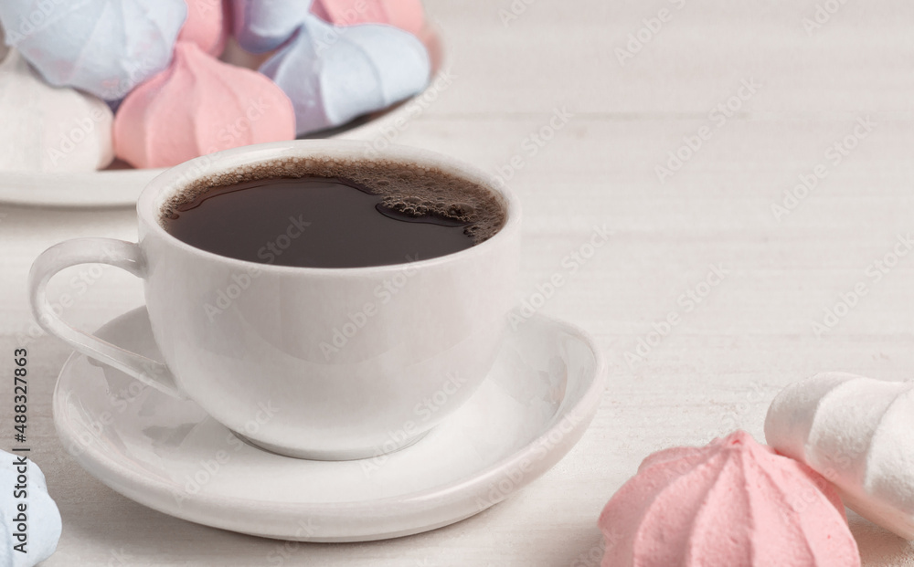A cup of espresso and meringue on a wooden table. A cup of espresso and meringue on a wooden table.