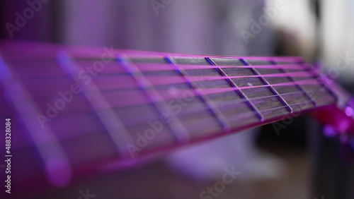 Obraz na plátne Acoustic guitar strings and fretboard on blurred background