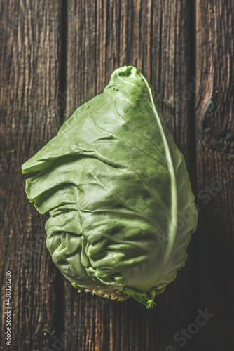 Canvas Print Close up of raw whole cabbage at rustic brown wooden background
