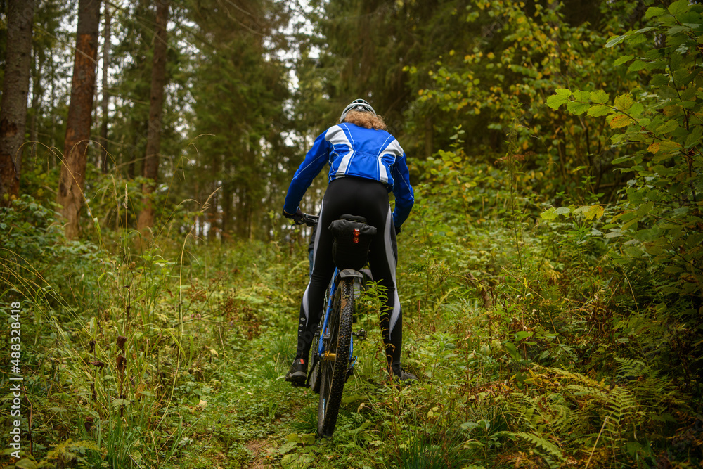 Fototapeta premium Bicyclist in the forest, Russia