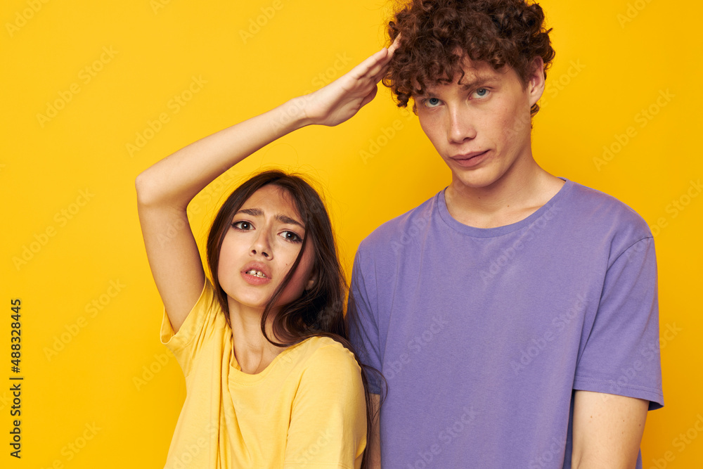 Fototapeta premium portrait of a man and a woman in colorful t-shirts posing friendship fun isolated background unaltered