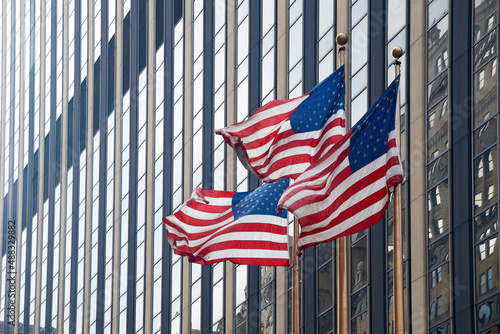 Obraz na płótnie Flags of the United States waving in the wind in New York City w salonie