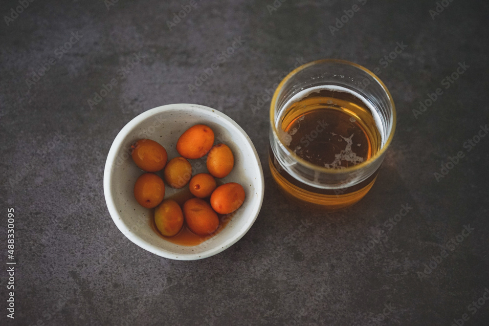 Image of a cold beer along with some olives Image of a cold beer along with some olives