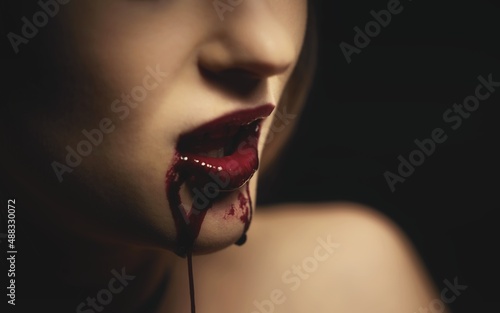 Woman with bloody mouth closeup photo