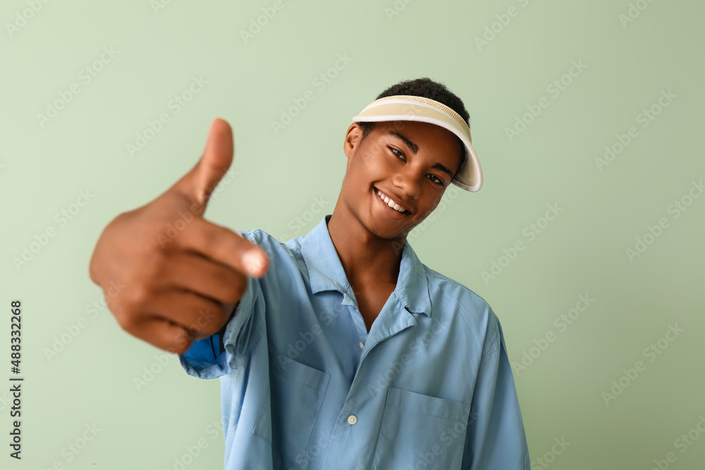 Handsome stylish African-American guy on color background Handsome stylish African-American guy on color background