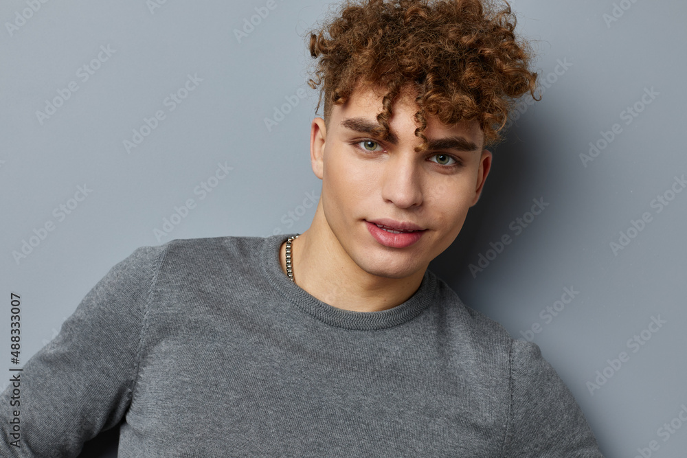 Fototapeta premium handsome guy in a gray sweatshirt fashion studio Lifestyle unaltered