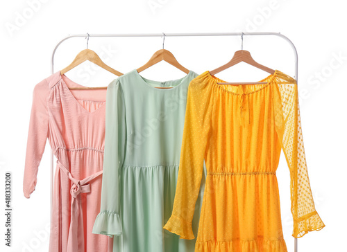 Fényképezés Rack with different trendy dresses on white background