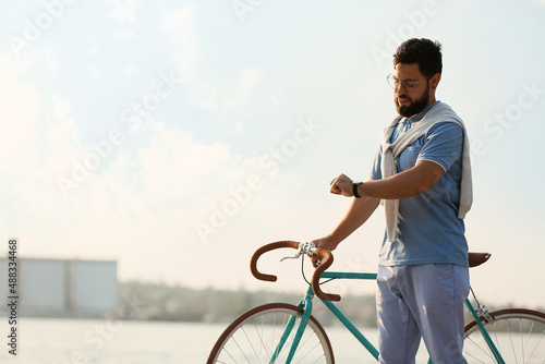 Young bearded man with bicy...