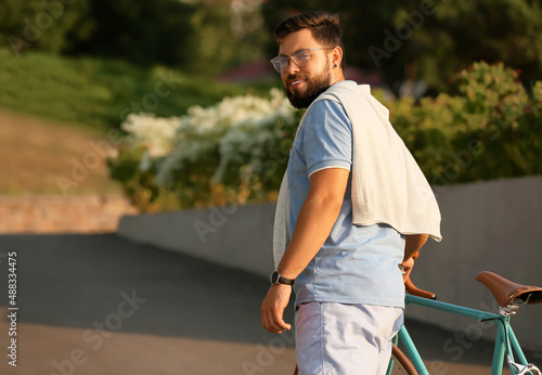 Young bearded man with bicy...