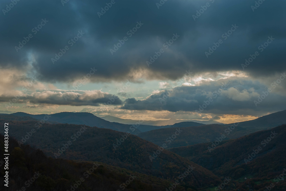 Mountainous landscape with a cloudy sunset sky Mountainous landscape with a cloudy sunset sky