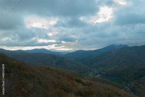 Mountainous landscape with a cloudy sunset sky © Simn
