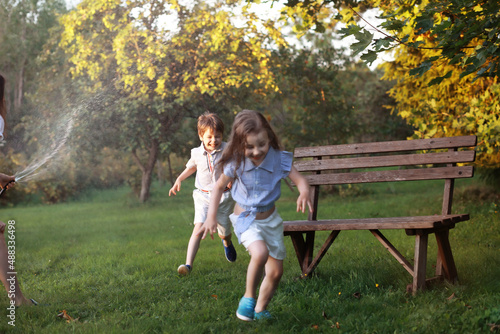 Children on a walk in the summer. Children indulge in the country. Laughter and splashing water.