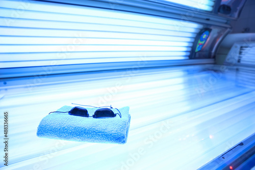 Towel and protective goggles on sunbed
