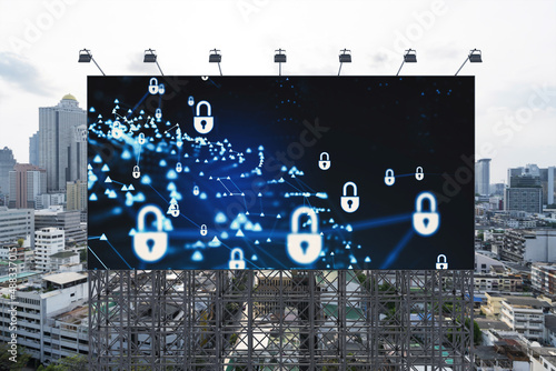 Padlock icon hologram on road billboard over panorama city view of Bangkok at day time to protect business, Southeast Asia. The concept of information security shields.