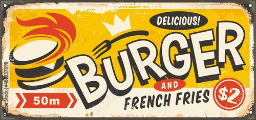 Delicious burger vintage tin sign board advertisement. Retro inscription for fast food restaurant or diner with cartoon style burger graphic and creative typography. Vector food illustration.