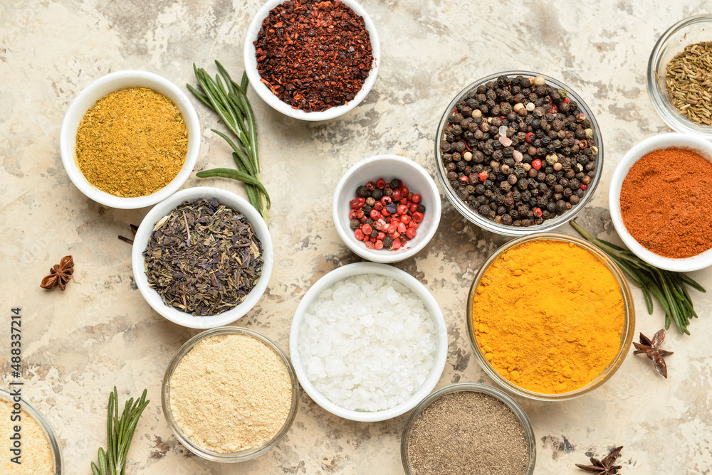 Bowls with different spices on grunge background Bowls with different spices on grunge background