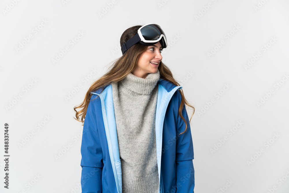 Skier girl with snowboarding glasses isolated on white background looking side Skier girl with snowboarding glasses isolated on white background looking side