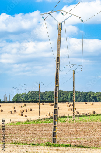 Alignement de poteaux électriques d'une ligne haute tension Edf traversant plusieurs champs photo