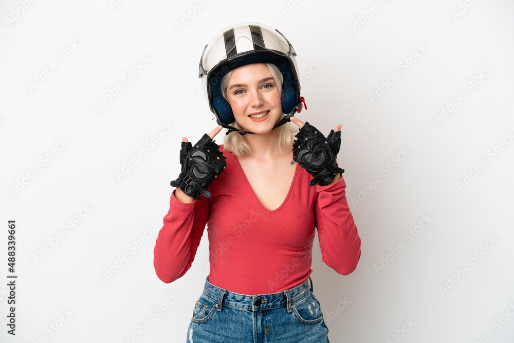 Young caucasian woman with a motorcycle helmet isolated on white background giving a thumbs up gesture Young caucasian woman with a motorcycle helmet isolated on white background giving a thumbs up gesture