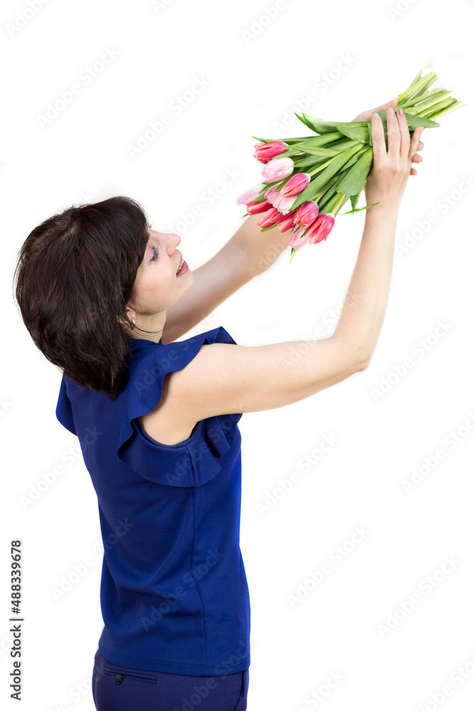 Portrait of a brunette with a beautiful smile with a bouquet of bright fresh tulips isolated white background. Portrait of a brunette with a beautiful smile with a bouquet of bright fresh tulips isolated white background.