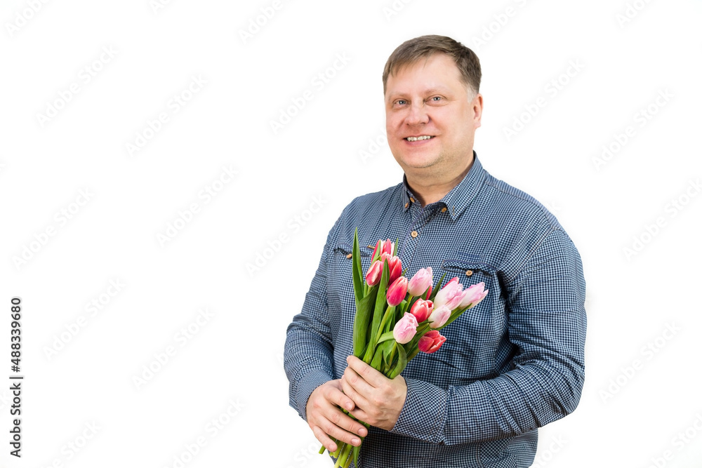 An adult male blonde holds out a bouquet of bright fragrant tulips, isolated, white background.