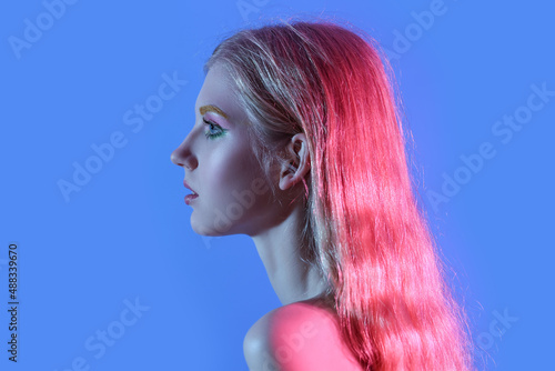 Beautiful girl with unusual eyebrows on color background