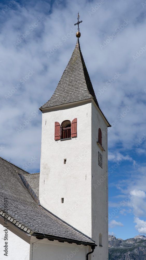 Fototapeta premium La Crusc. The bell tower of the church. Typical Tyrolean church tower. General context. Badia, Alto Adige, South Tyrol, Italy