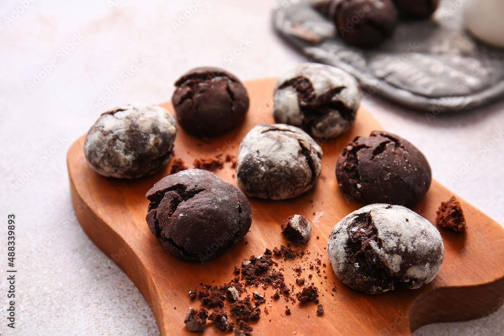 Wooden board of chocolate brownie cookies on light background, closeup Wooden board of chocolate brownie cookies on light background, closeup