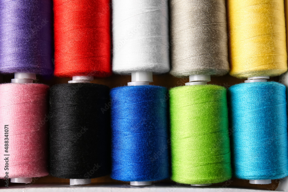 Spools with sewing threads as background, closeup Spools with sewing threads as background, closeup