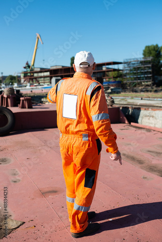 Shipyard worker on a barge in the port