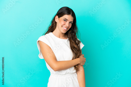 Young caucasian woman isolated on blue background laughing © luismolinero