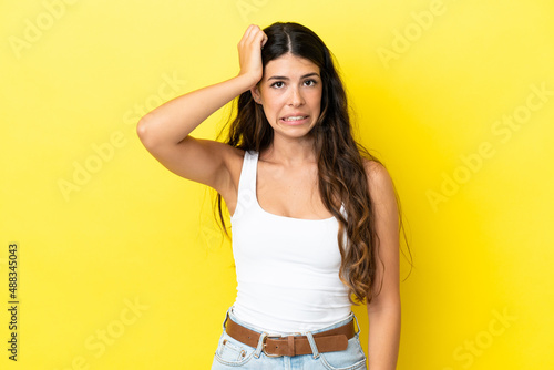 Young caucasian woman isolated on yellow background with an expression of frustration and not understanding