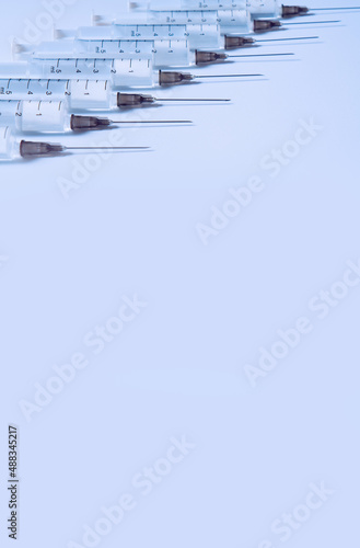 Vaccination. Row of syringes with a copy space.